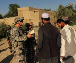 US First Lieutenant Mahard of 2nd Platoon Alpha 3-71 Cavalry talks with local villagers during a patrol mission at Sarbland village in the Baraki Barak district of Logar Province on August 14, 2009. More than 10 percent of planned voting stations could be closed in Afghanistan during landmark elections because of safety fears, officials said, as escalating violence killed 14 civilians.  AFP PHOTO/  MANAN VATSYAYANA